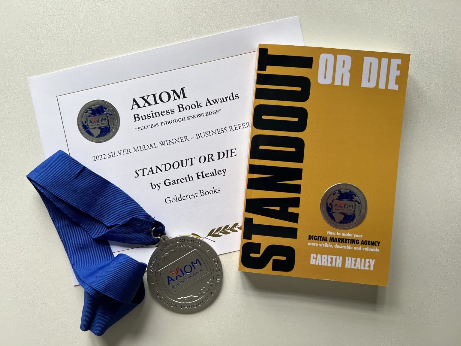 Image of STANDOUT OR DIE book, certificate and silver medal